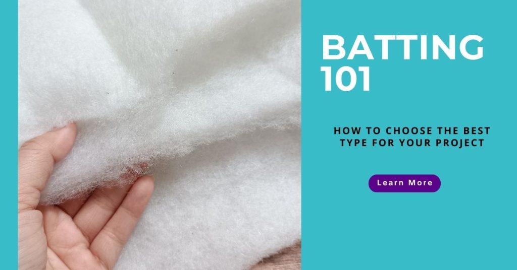 hand reaching from the left to touch white quilting batting