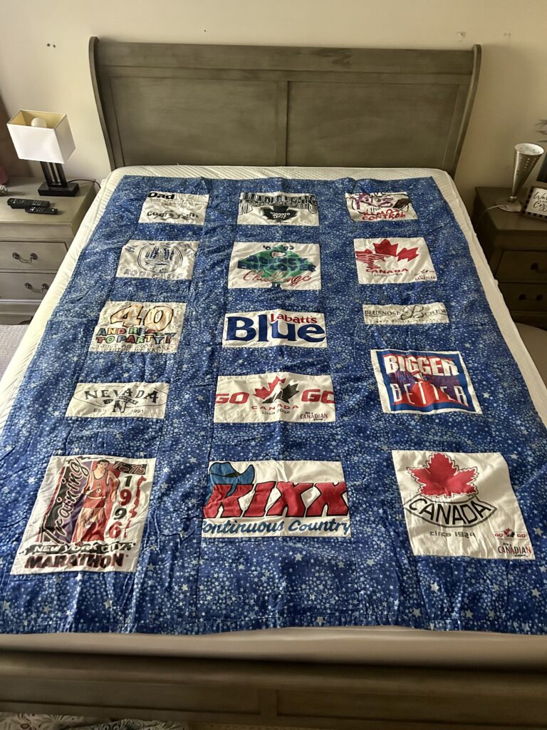 A colourful quilt made of t-shirts. t-shirt quilt.