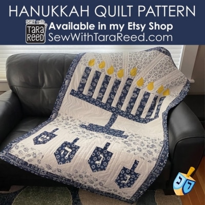 A colourful quilt for Hanukkah featuring a menorah and dreidels
